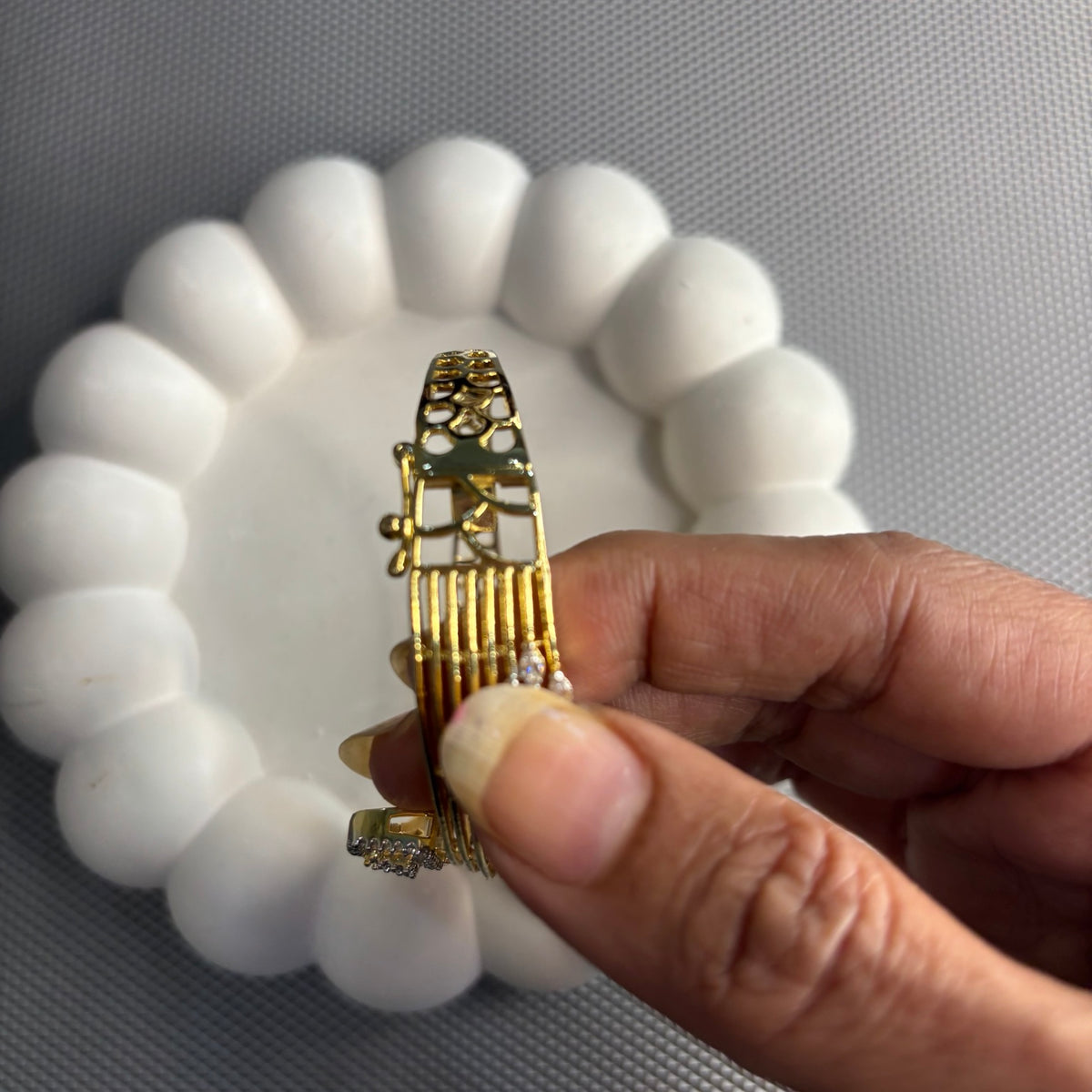 Side detail of Anshi bracelet showing the hinge and clasp