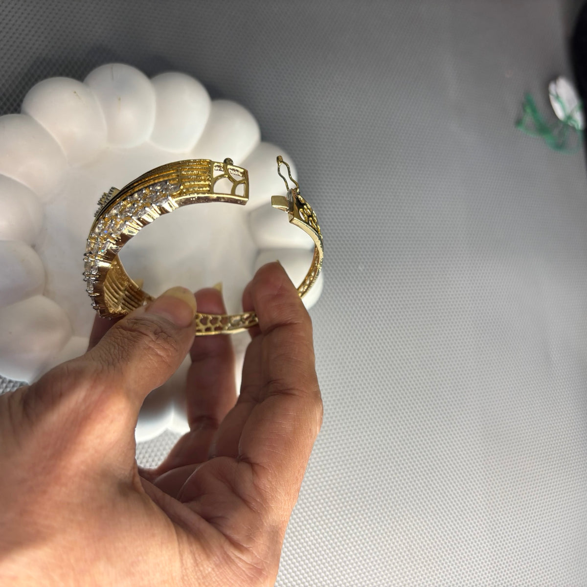 Anshi gold-plated CZ bracelet opened to show the locking clasp