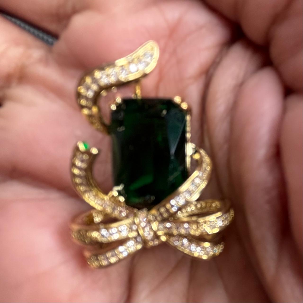 Emerald green crystal bow brooch pin with gold finish and sparkling cubic zirconia stones for sarees blazers coats dresses by Bebaak Jewels