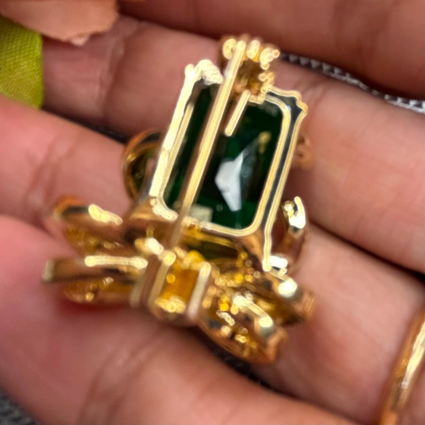 Emerald green crystal bow brooch pin with gold finish and sparkling cubic zirconia stones for sarees blazers coats dresses by Bebaak Jewels