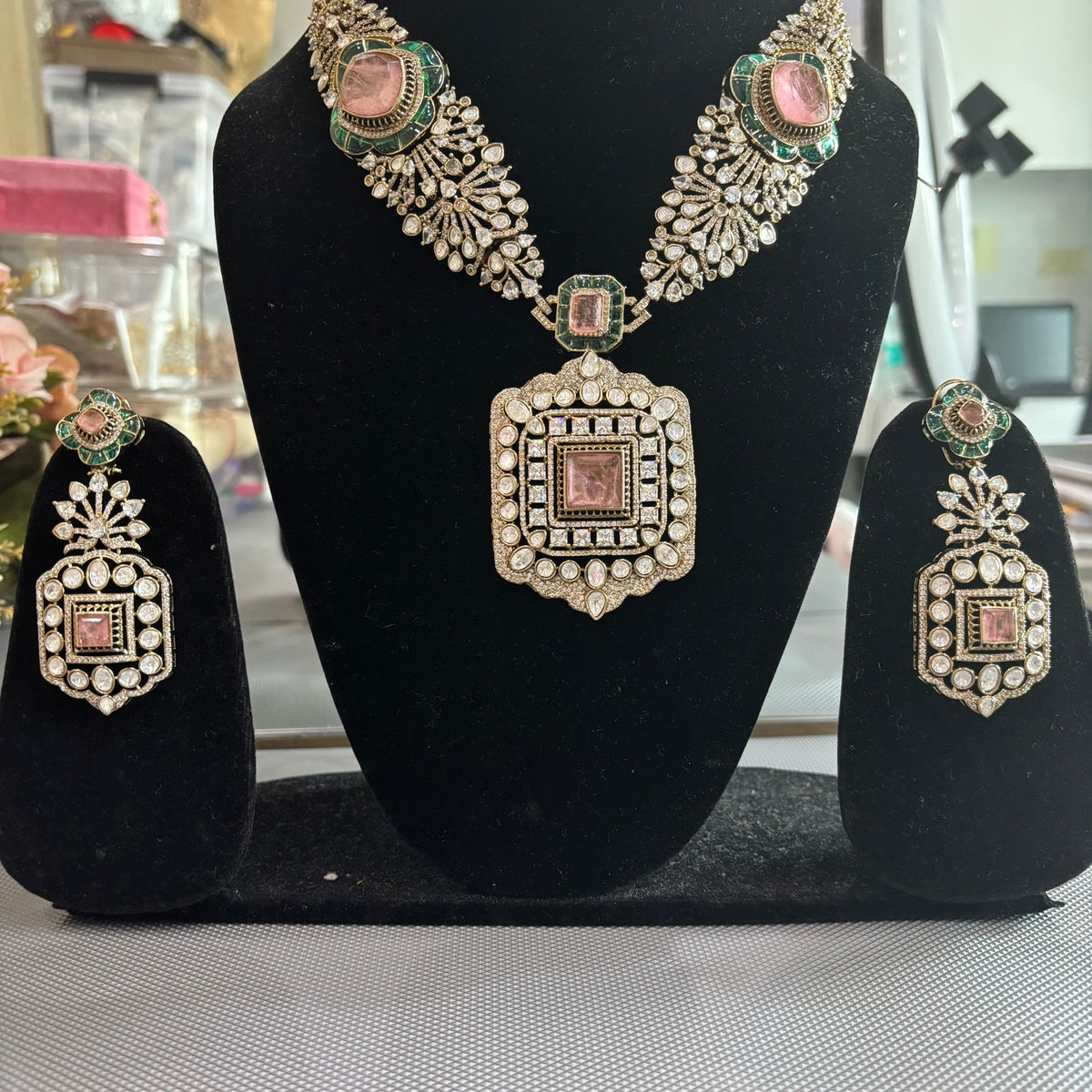 Kai necklace and earrings featuring rectangular pink centres surrounded by clear stones