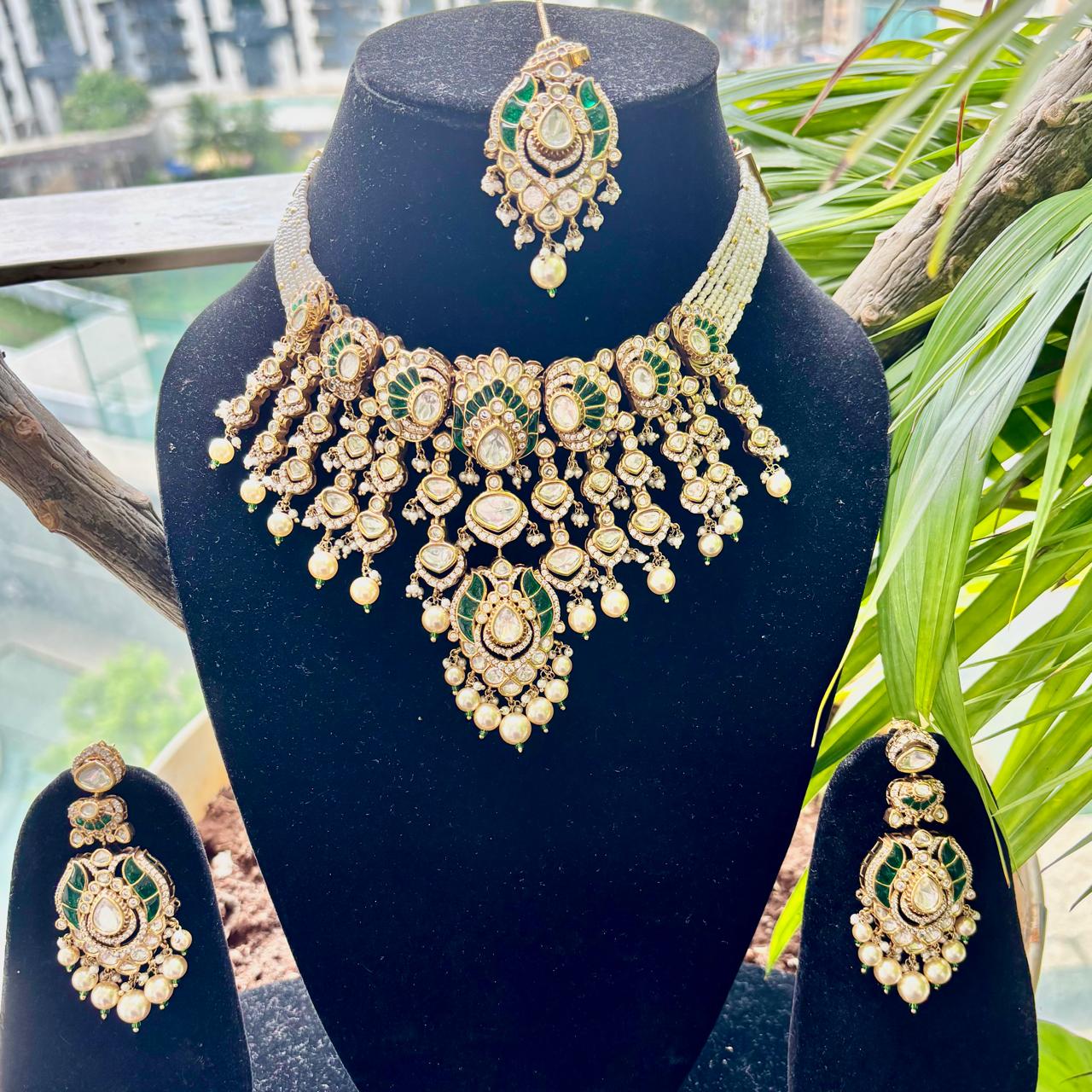 Luxury Emerald Green Kundan Bridal Necklace Set with Matching Earrings and Maang Tikka by Bebaak Jewels.